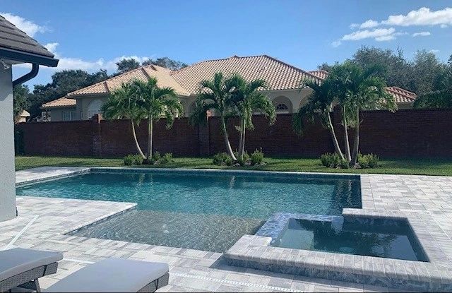 Custom Next Level pool with attached spa and paver deck