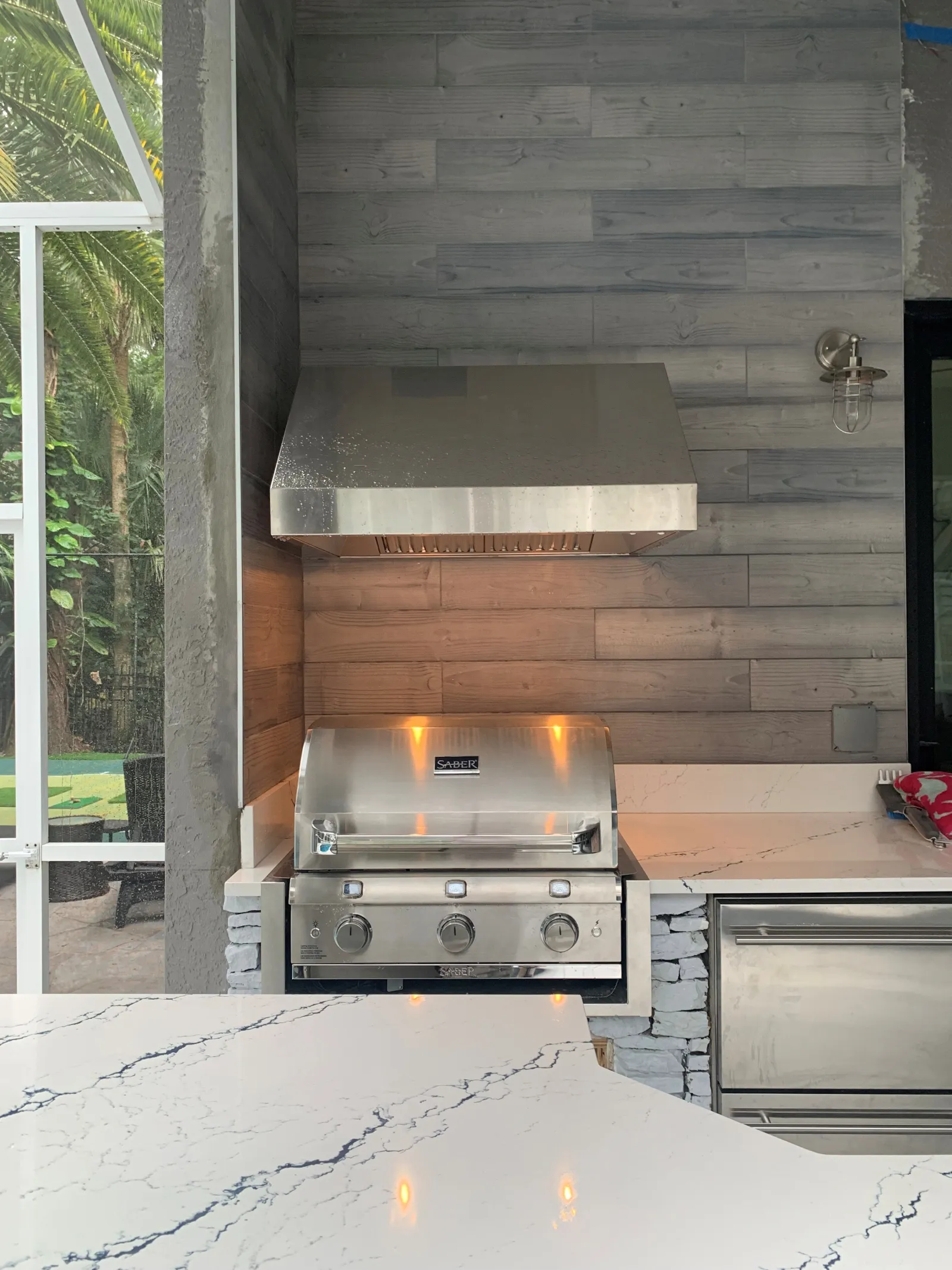 Modern residential pool with outdoor kitchen and living space